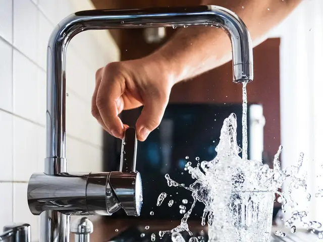 Plumber answering service for emergency calls Plumber testing a repaired kitchen faucet with running water — the AI Phone 360 plumber answering service handles the calls meanwhile.